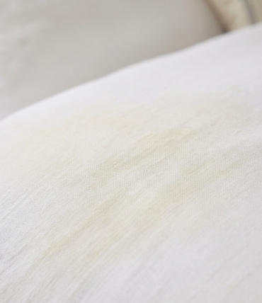 Why does white bedding turn yellow and how can you prevent it?
