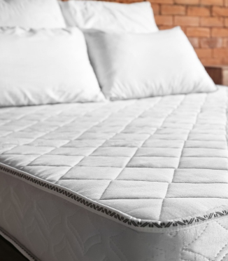 Why is it important to regularly wash pillows and mattresses