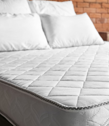 Why is it important to regularly wash pillows and mattresses
