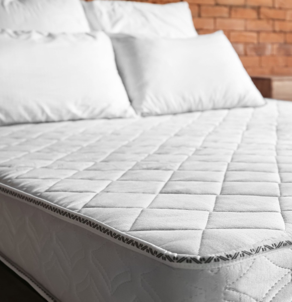 Why is it important to regularly wash pillows and mattresses