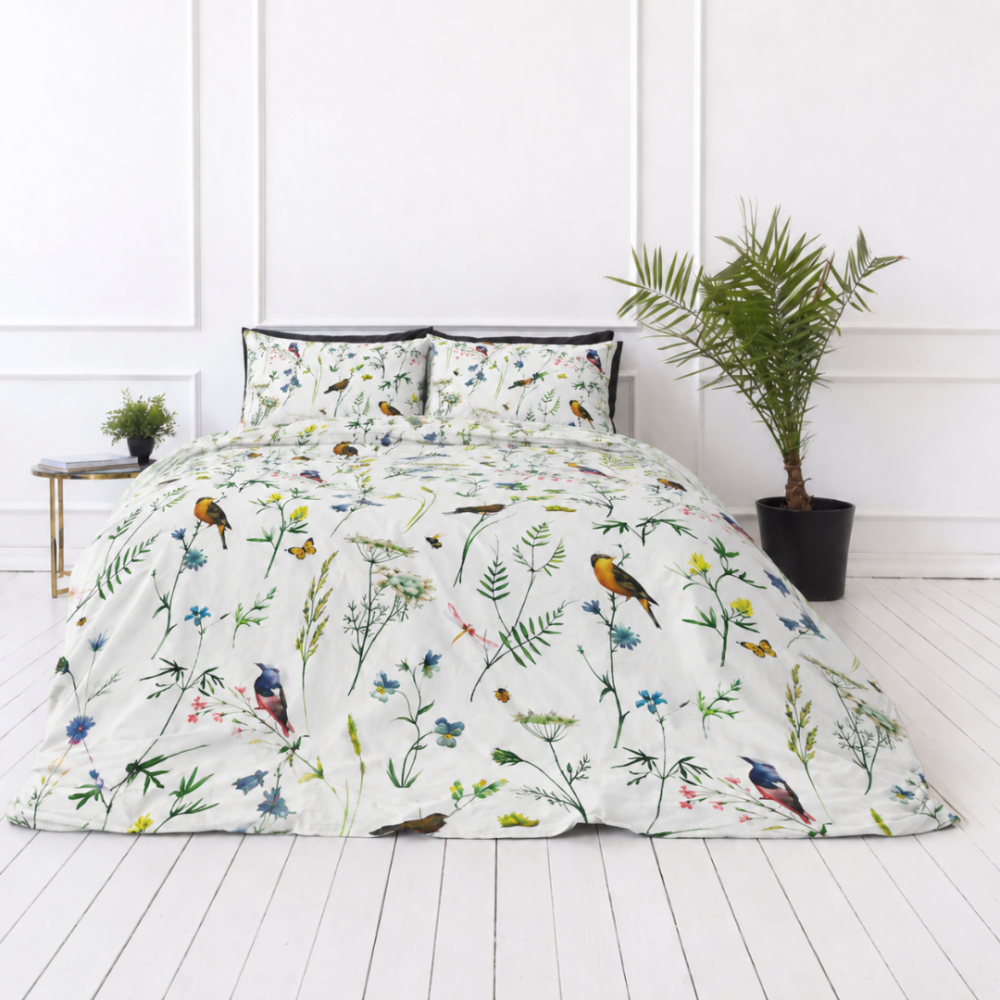 Bedding Set „Song Nest“. Patterned bedding sets, 140x200 cm, 200x200 cm, 200x220 cm. Light cotton with illustrations – yellow bullfinches, blue flowers, and small green leaves in a white composition.