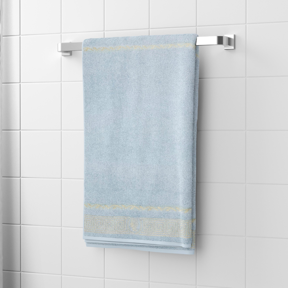 Bath towel “Glacier Olympian”, 70x140 cm. Pastel blue towel with a greek golden ornament pattern at the bottom.