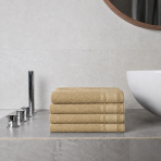 Bath towel “Gold Olympian”, 70x140 cm. Warm yellow towel with a decorative geometric border pattern.