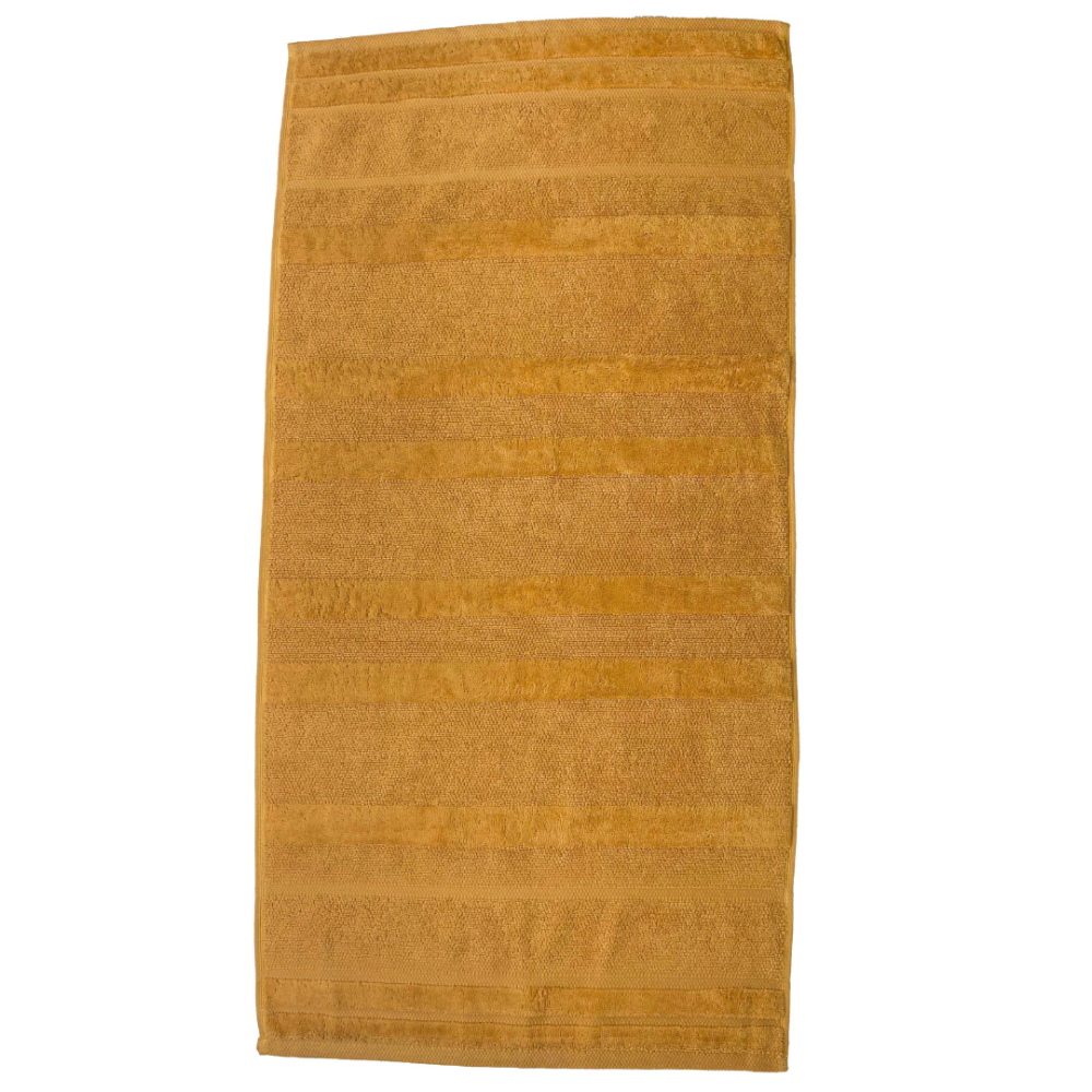 Bath towel “Terry Mustard”, 50x90 cm, 70x140 cm. Elegant mustard cotton bath towel, combines softness and high absorbency, ideal for a vibrant and sophisticated bathroom look.
