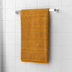 Bath towel “Terry Mustard”, 50x90 cm, 70x140 cm. Luxurious mustard cotton bath towel, plush and durable, offering a cozy and elegant experience for your daily bath routine.